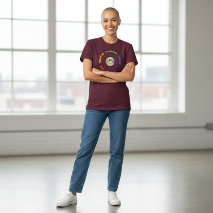 Jena Jewelry maroon 100% cotton t-shirt with a rainbow smiley face graphic and text that reads "Be The Reason Someone Smiles Today".