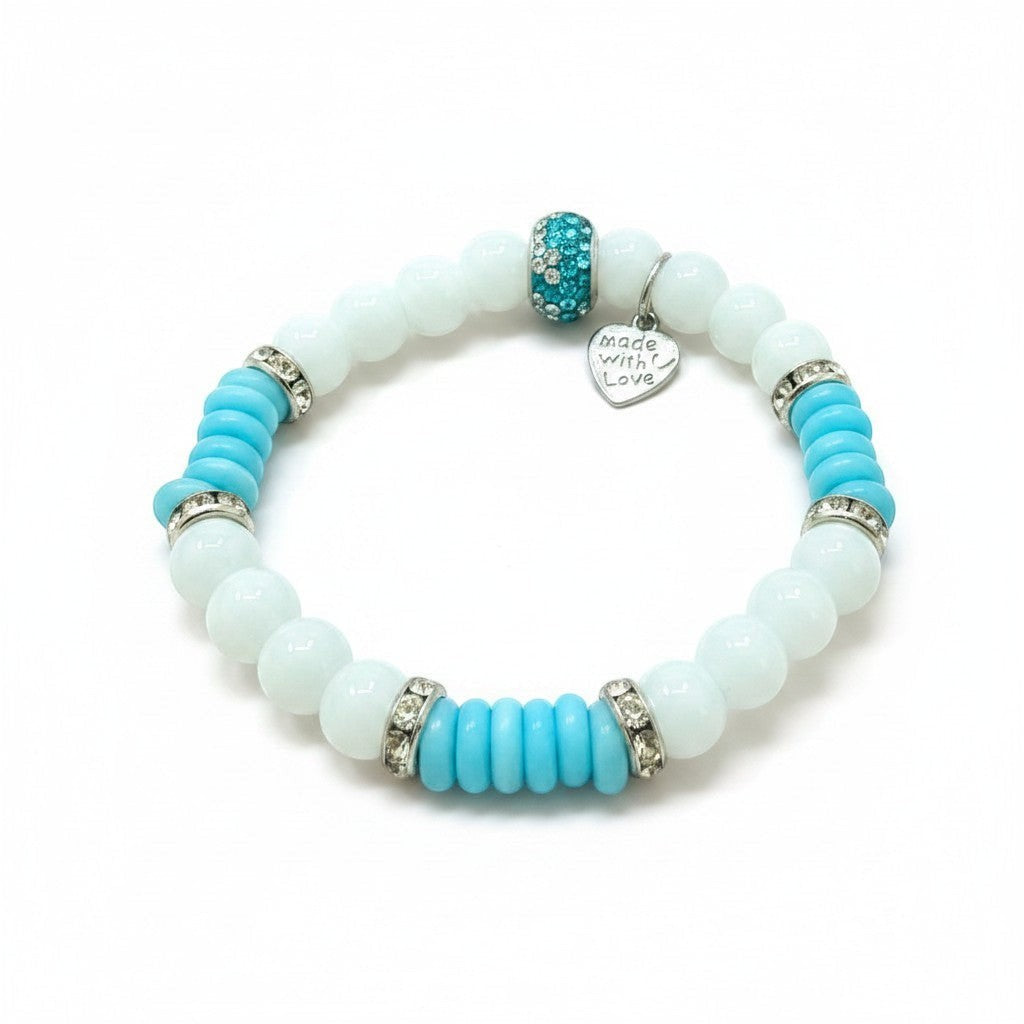 Jena Jewelry handmade stretch bracelet with white snow jade, blue cat eye disks, and rhinestone spacers. Features a heart charm that says "Made with Love".