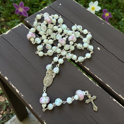 Jena Jewelry Snow Jade and Antique Floral Lampwork Rosary with silver crucifix and medallion. Features white jade beads and lampwork glass beads with pink floral designs.
