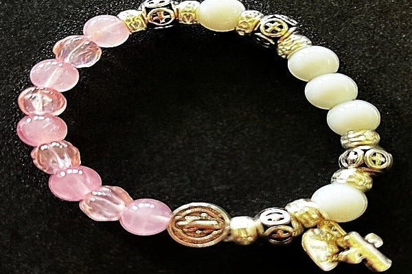 Jena Jewelry snow jade and rose quartz rosary bracelet with silver plate spacers and a crucifix charm.