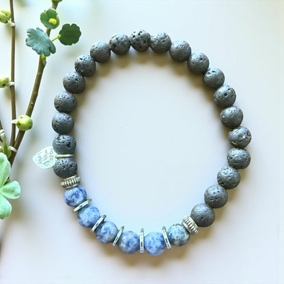 Jena Jewelry sodalite, hematite, and lava stone stretch bracelet with silver accents. Blue sodalite beads alternate with dark grey lava stone beads.