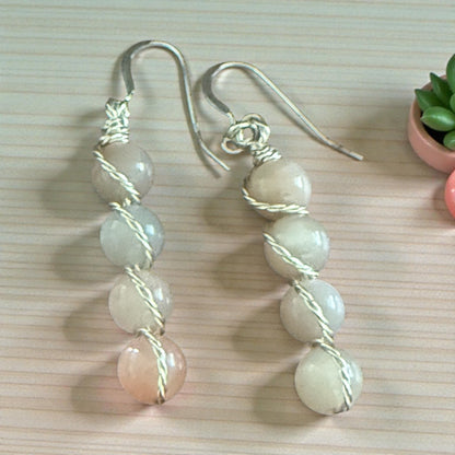 Jena Jewelry stacked drop earrings with pale peach, grey, and white gemstone beads wire-wrapped in silver.