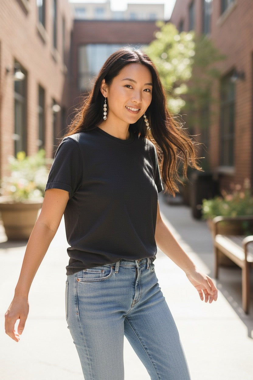Jena Jewelry stacked pearl drop earrings on a woman wearing a black t-shirt and jeans. Elegant, handcrafted, and versatile.