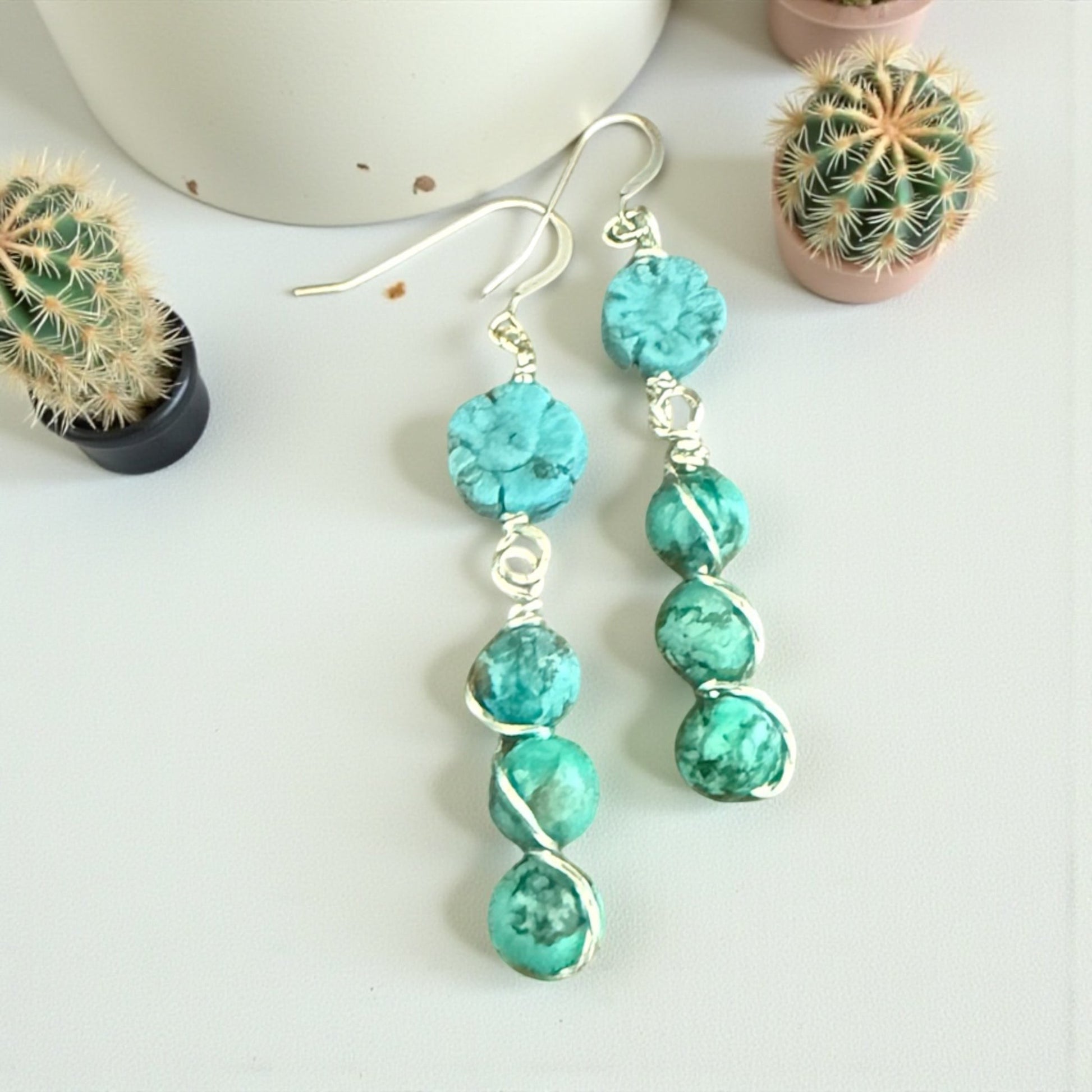 Jena Jewelry stacked turquoise gemstone drop earrings with silver-tone wire wrapping and hypoallergenic ear wires.