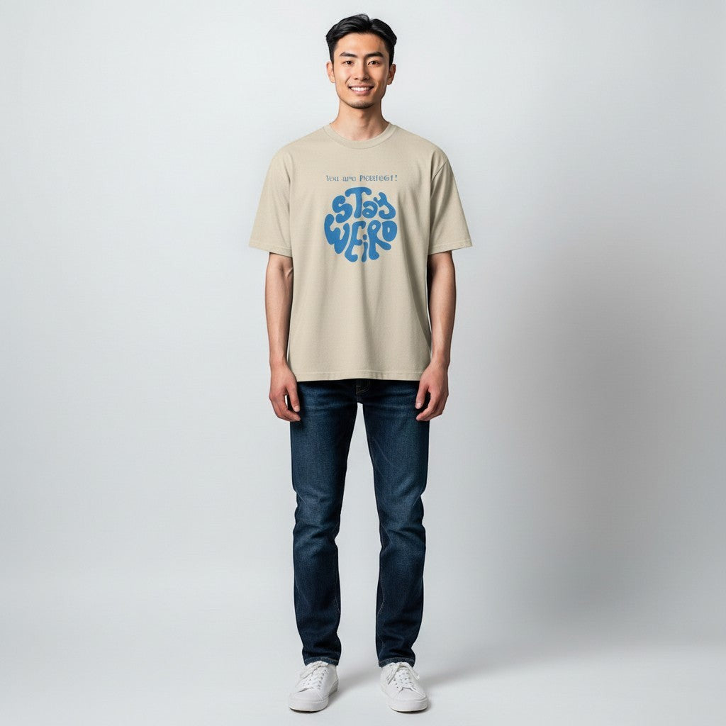 Jena Jewelry beige 100% cotton t-shirt with blue "Stay Weird" graphic and "You are perfect!" text.