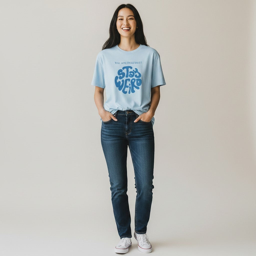 Jena Jewelry light blue 100% cotton t-shirt with a retro blue psychedelic graphic that says "Stay Weird" and "You are perfect!".