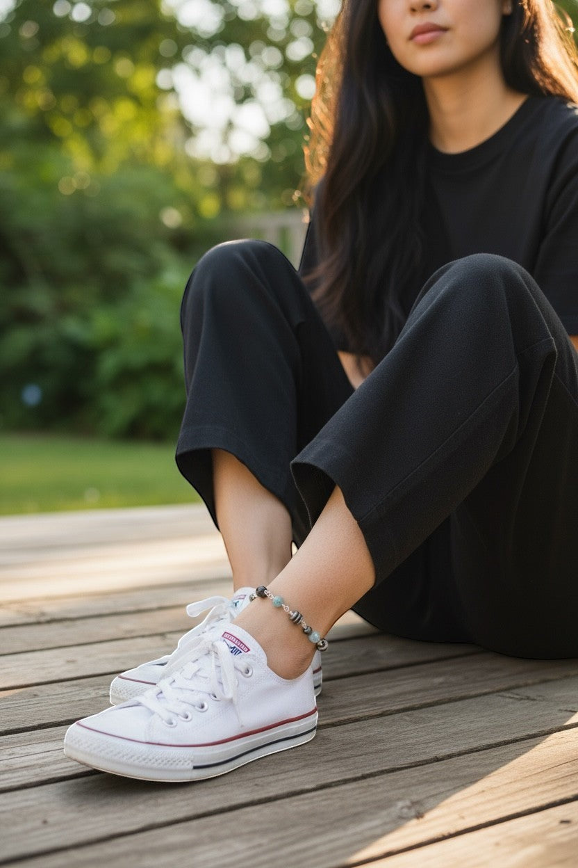 Jena Jewelry anklet with Hematite, Rose Quartz, Indigo, Black Onyx, and Jasper beads on a woman's ankle.