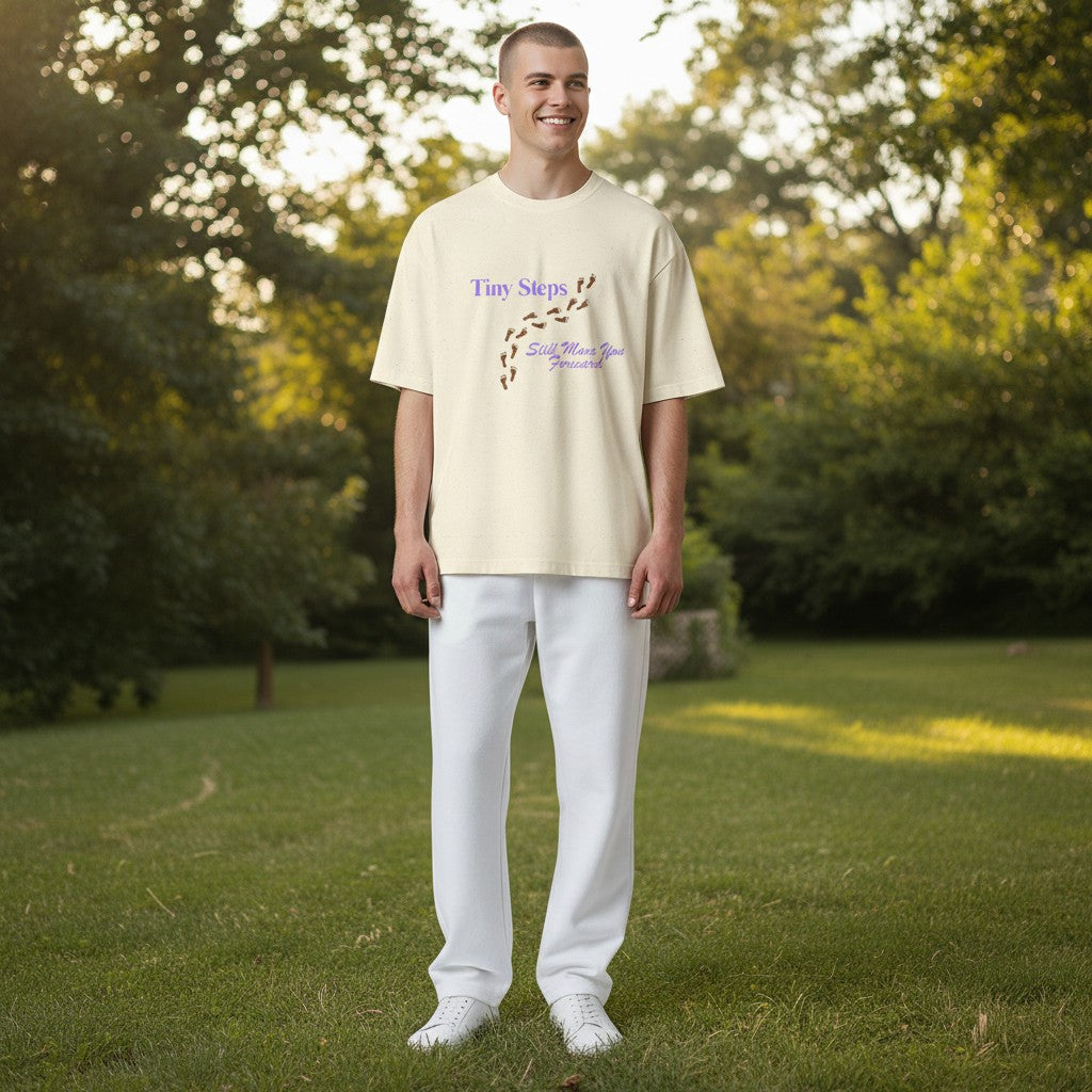 Jena Jewelry cream 100% cotton t-shirt with "Tiny Steps" and footprints graphic. Relaxed fit.