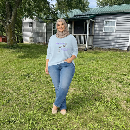 Jena Jewelry light blue 100% cotton t-shirt with "Tiny Steps" and footprints graphic. Inspirational tee.