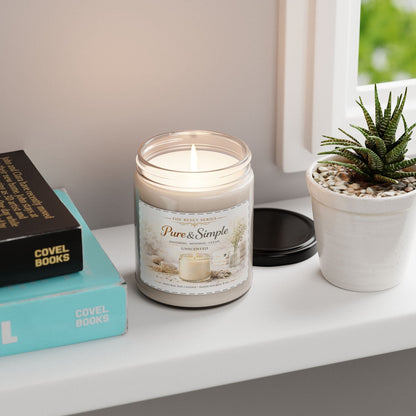 Jena Jewelry unscented soy candle in a clear glass jar with a white label, burning with a soft flame.