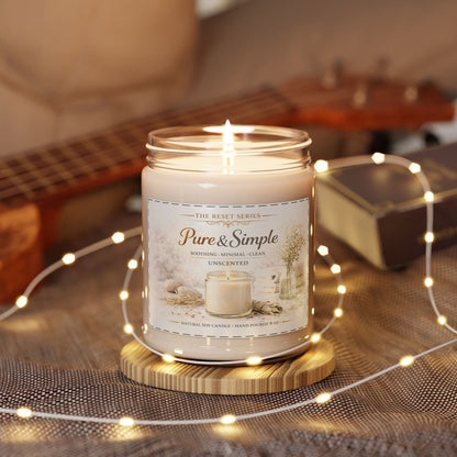 Jena Jewelry unscented soy candle in a glass jar with a minimalist label, set on a wooden coaster with fairy lights.