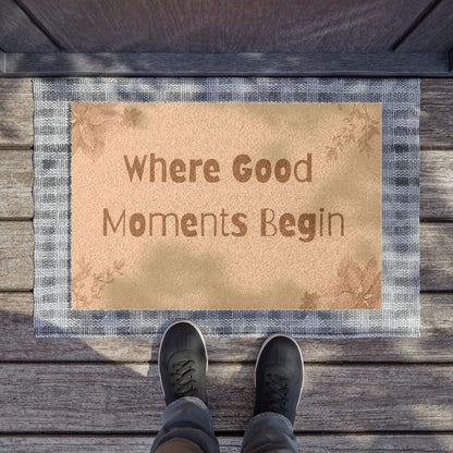 Jena Jewelry floral welcome doormat with "Where Good Moments Begin" text, made of natural coir with a grey plaid border.