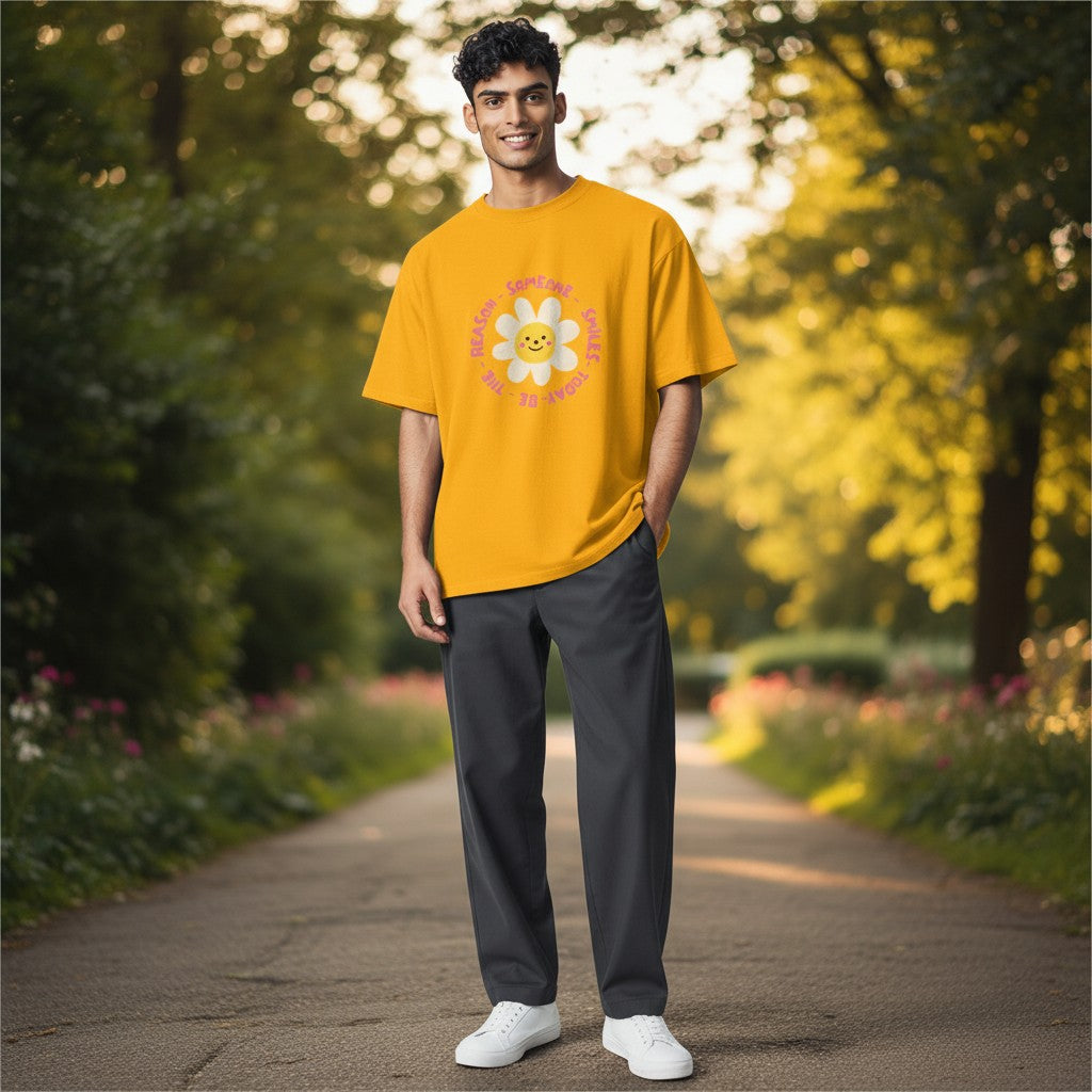 Jena Jewelry yellow 100% cotton t-shirt with a smiling daisy graphic and the text “Be the Reason Someone Smiles Today”