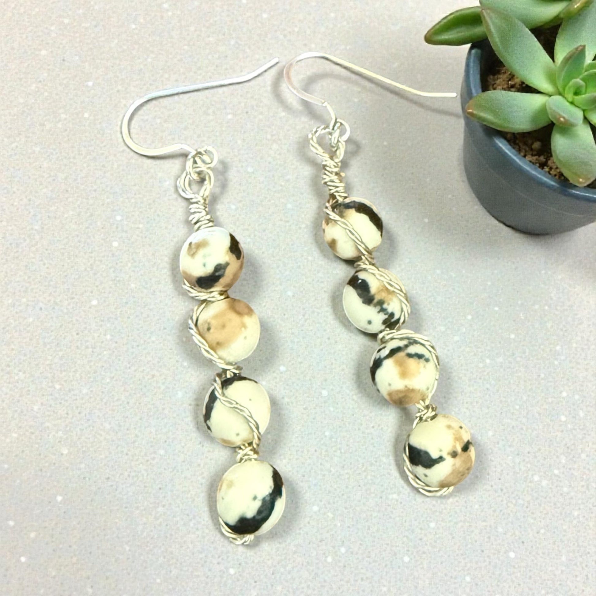 Jena Jewelry stacked drop earrings with cream, tan, and black Zebra Jasper beads, wire-wrapped with silver-tone metal.