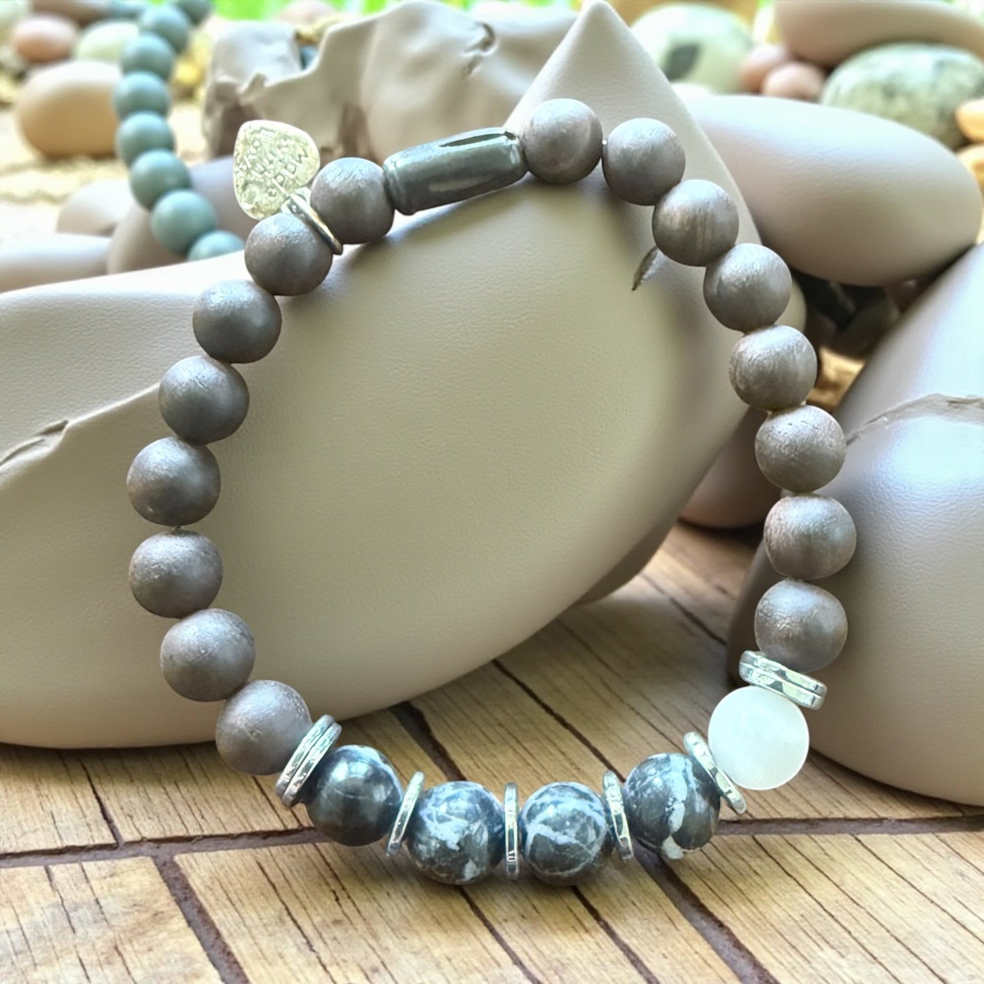 Jena Jewelry grounding strength bracelet with Zebra Jasper, Ebony mala beads, and Hematite. Features monochrome stones and silver accents.
