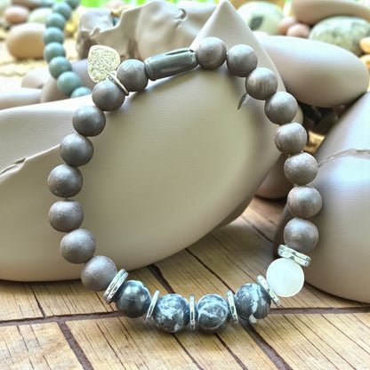 Jena Jewelry grounding strength bracelet with Zebra Jasper, Ebony mala beads, and Hematite. Features monochrome stones and silver accents.