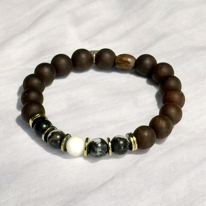 Jena Jewelry stretch bracelet with Zebra Jasper, Ebony Blackwood mala beads, and Hematite, accented with gold spacers.