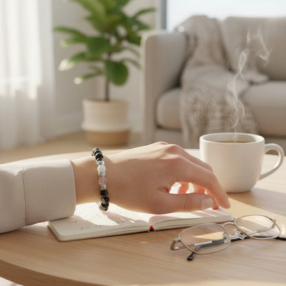 Jena Jewelry stretch bracelet with black zebra jasper, rose quartz, and silver beads on a woman's wrist.