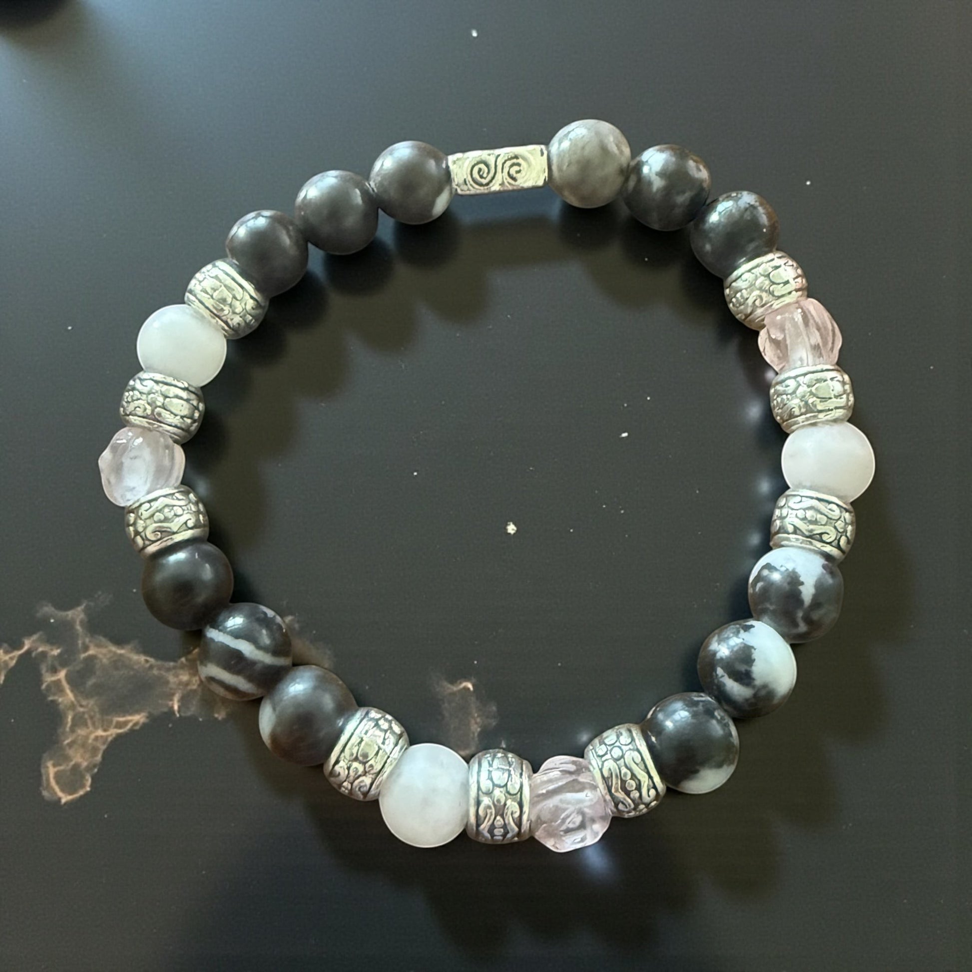 Jena Jewelry stretch bracelet with zebra jasper, rose quartz, and white agate beads, accented with silver spacers.