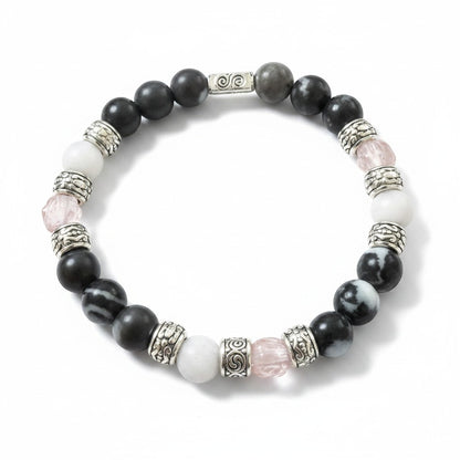 Jena Jewelry stretch bracelet with black zebra jasper, white jade, rose quartz beads, and silver spacers for strength and love.