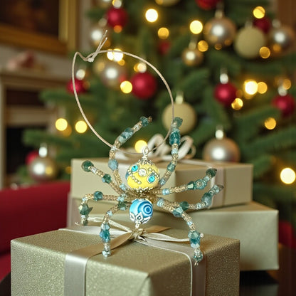Jena Jewelry handcrafted Christmas spider ornament with yellow and blue beads, silver wire legs, and a blue swirl detail on its body.