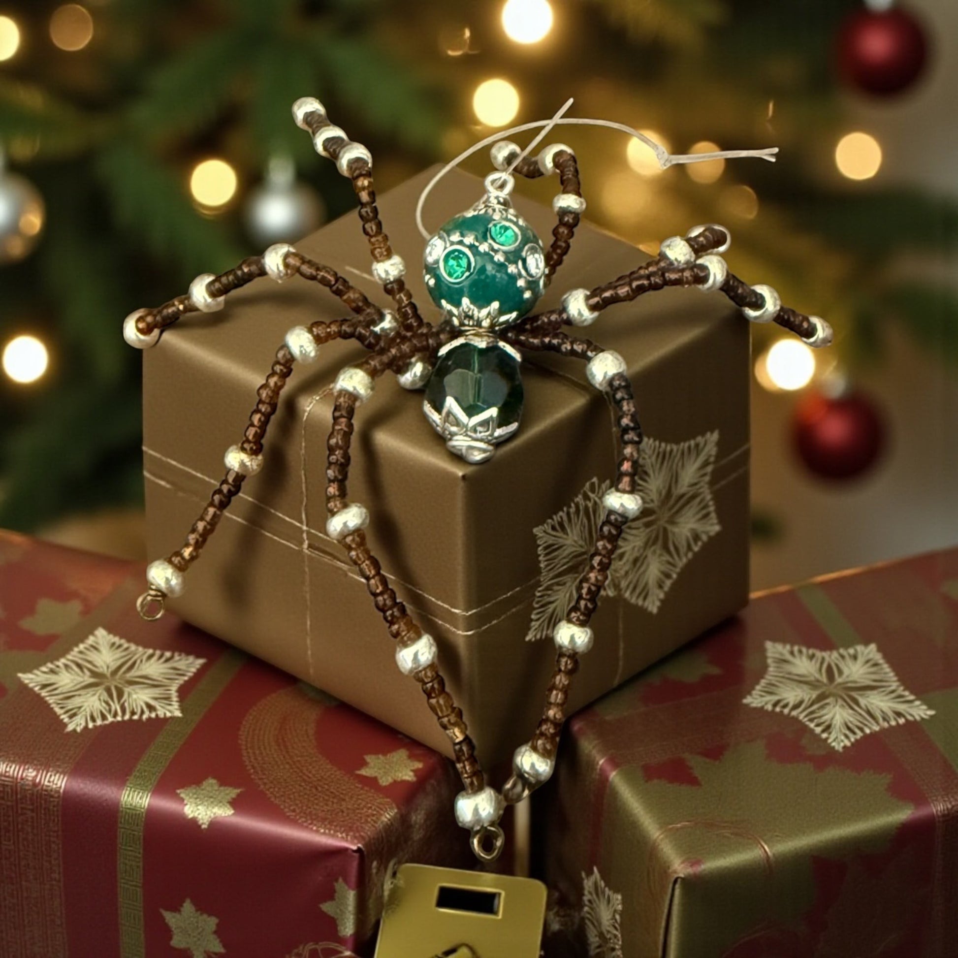 Jena Jewelry handcrafted Christmas spider ornament with green beads and silver accents, made of glass beads and wire.