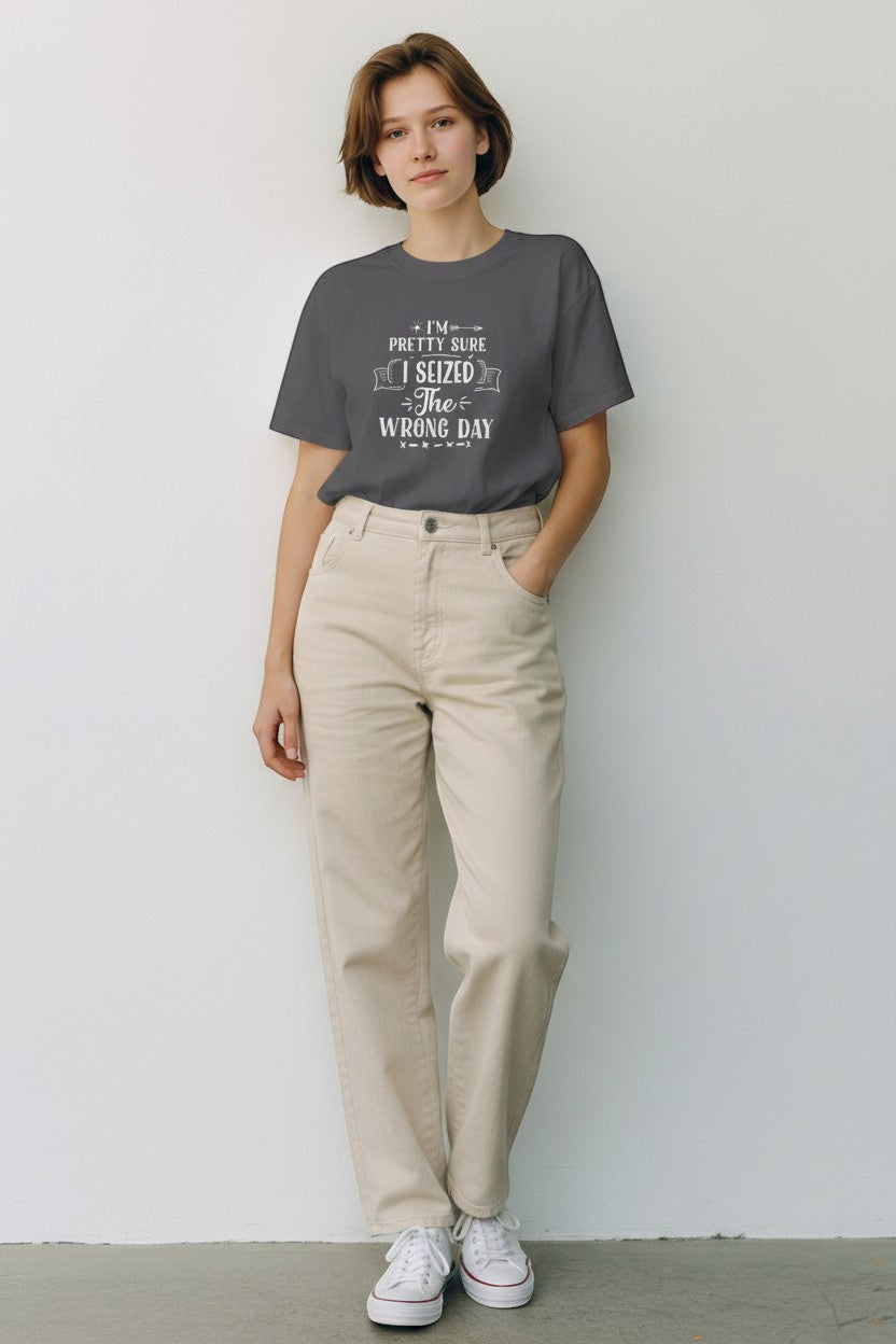Jena Jewelry dark grey 100% cotton t-shirt with white 'I Seized the Wrong Day' graphic print, worn by a woman.