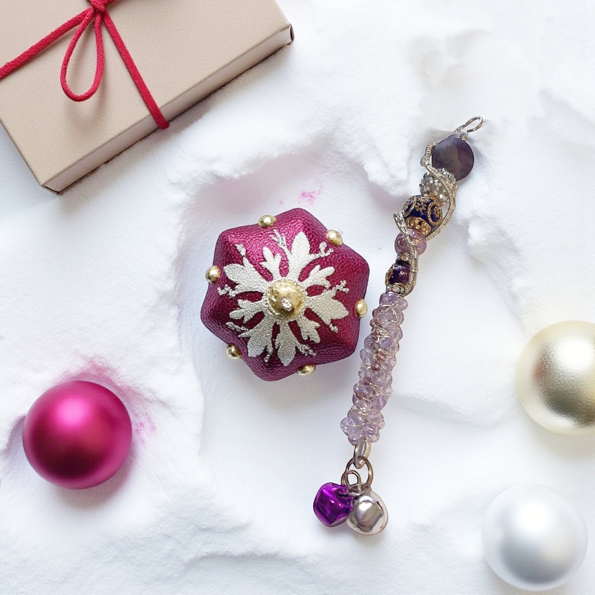 Jena Jewelry handcrafted festive icicle ornament with beads, charms, and jingle bells. Includes a small gift box.
