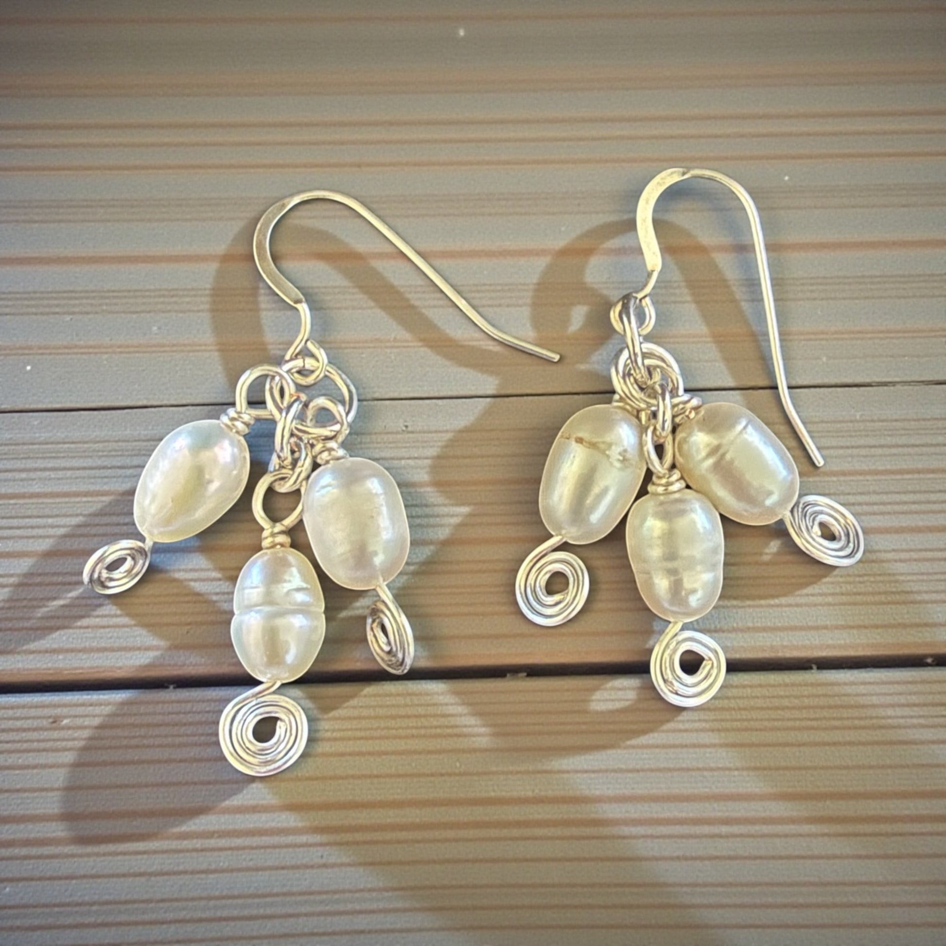 Jena Jewelry elegant spiral freshwater pearl drop earrings with silver-tone wirework and hypoallergenic ear wires.