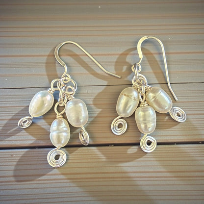 Jena Jewelry elegant spiral freshwater pearl drop earrings with silver-tone wirework and hypoallergenic ear wires.