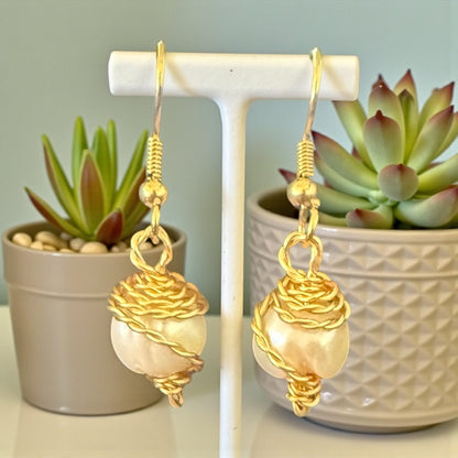 Jena Jewelry gold-wrapped freshwater pearl earrings with a nest-like wire design. Lustrous pearls with iridescent glow.