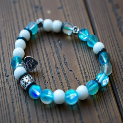 Jena Jewelry "Let It Go!" stretch bracelet with blue mermaid beads, snow jade, and hematite, spelling out Morse code.