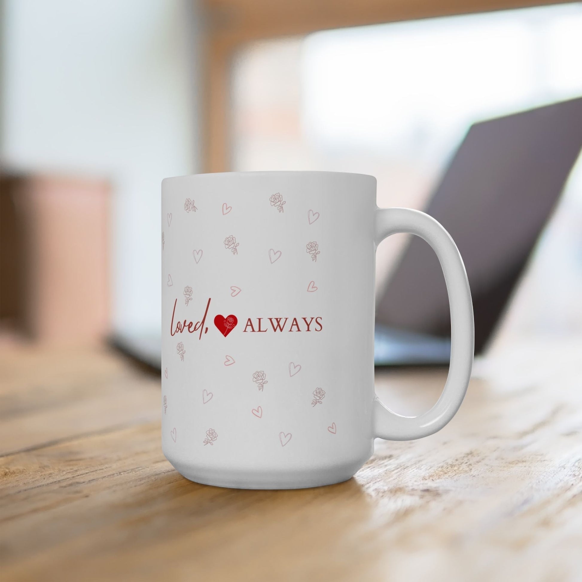 Jena Jewelry white ceramic mug with red "Loved Always" text, heart, and rose pattern. Perfect for gifts.