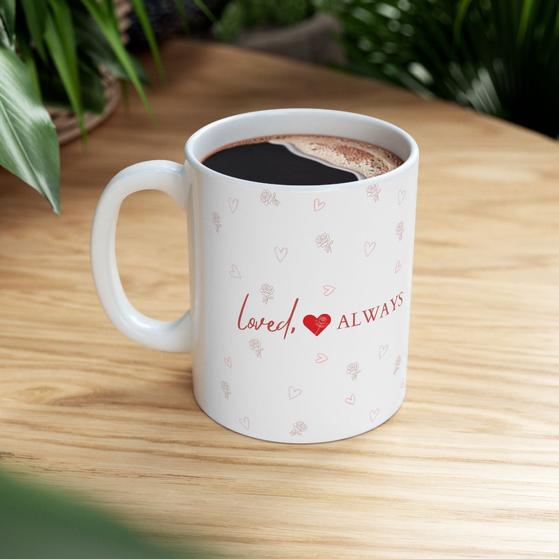 Jena Jewelry white ceramic mug with "Loved Always" text and small heart and rose pattern. Perfect for gifts.