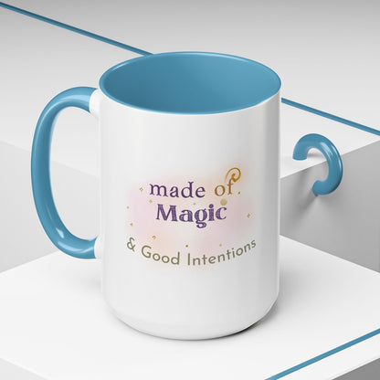 Jena Jewelry white ceramic mug with blue interior and handle, featuring "Made of Magic & Good Intentions" text and watercolor design.