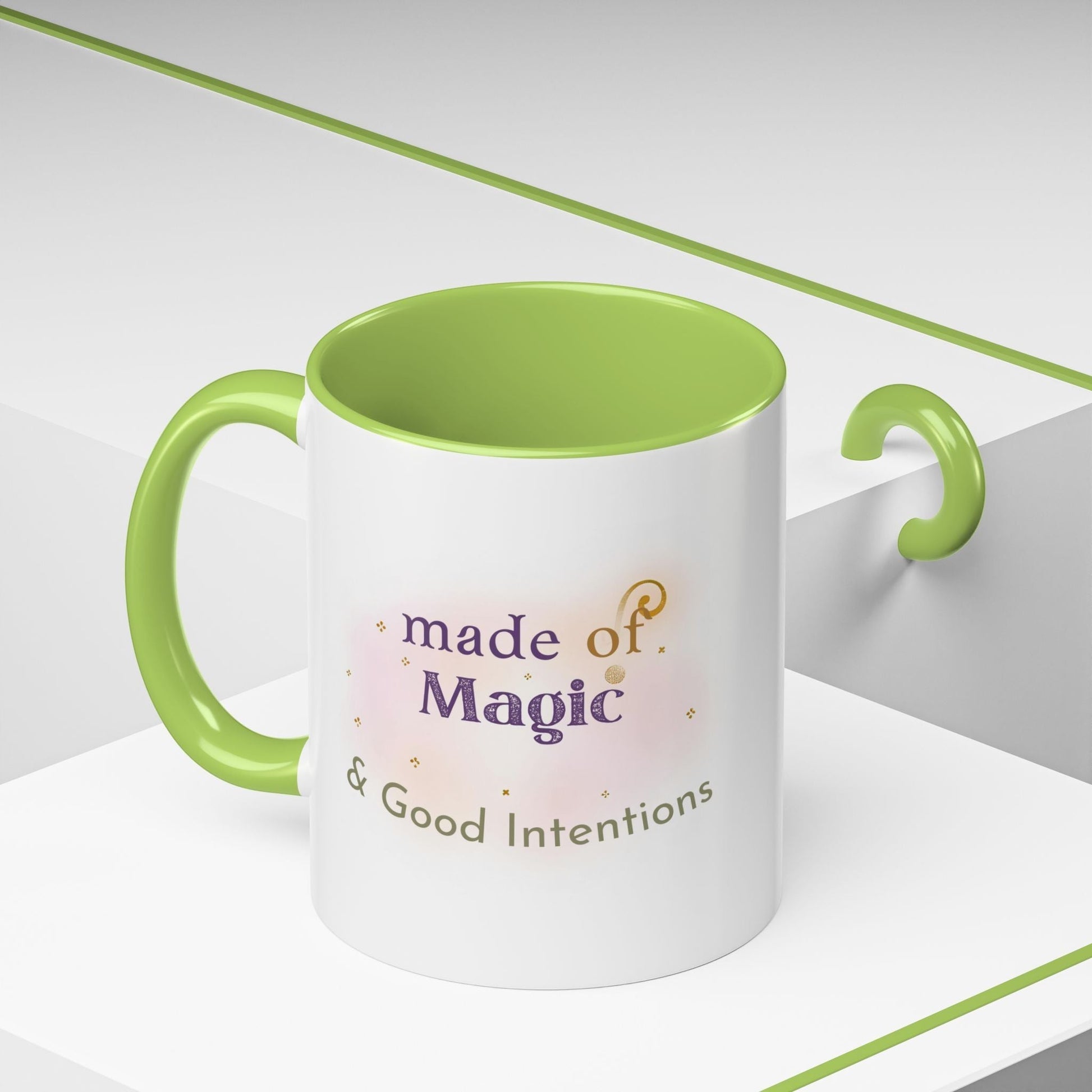 Jena Jewelry white ceramic mug with green interior and handle, featuring "made of Magic & Good Intentions" text.