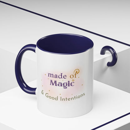 Jena Jewelry white ceramic mug with navy blue interior and handle, featuring "made of Magic & Good Intentions" text.