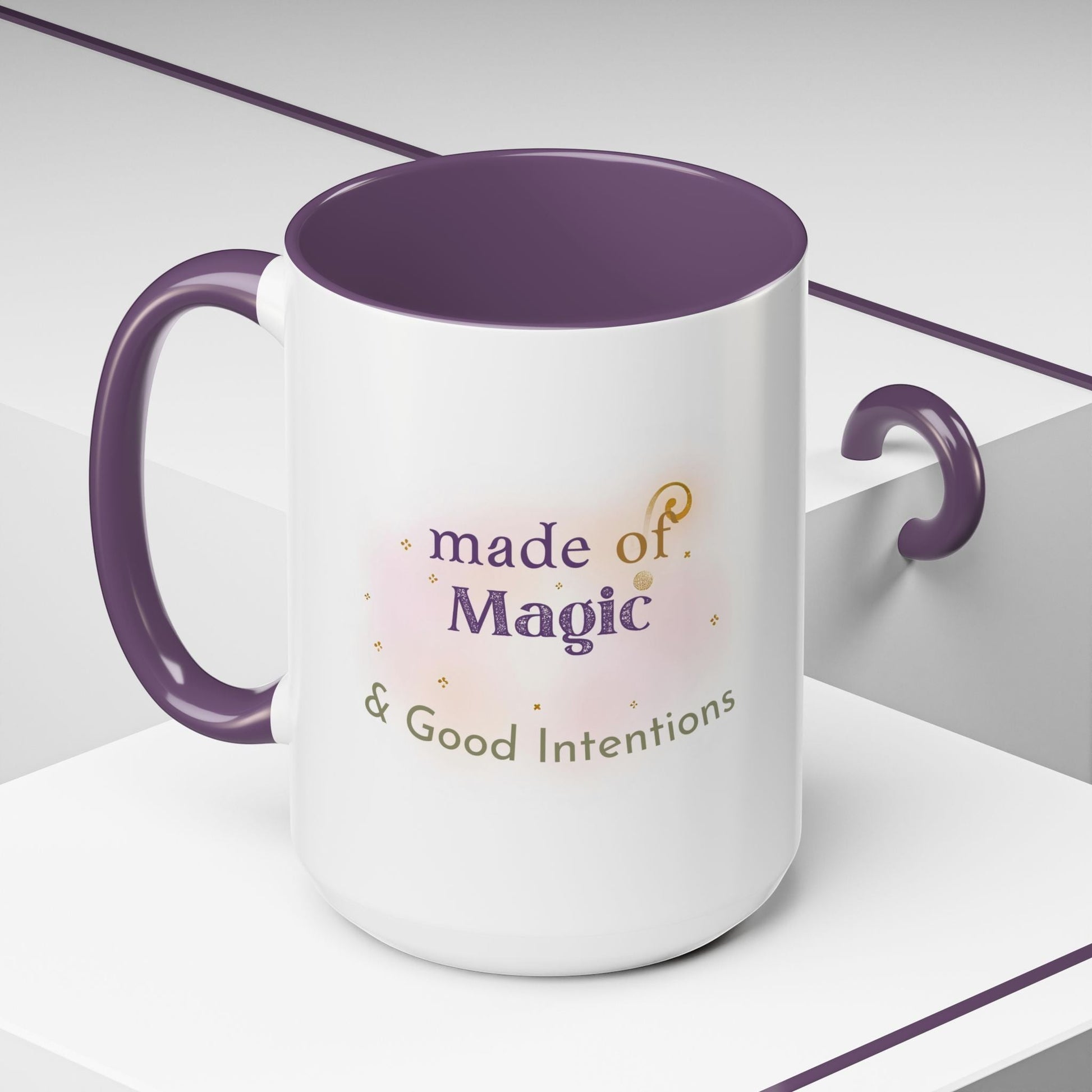 Jena Jewelry white ceramic mug with purple interior and handle, featuring "made of Magic & Good Intentions" text and watercolor accents.