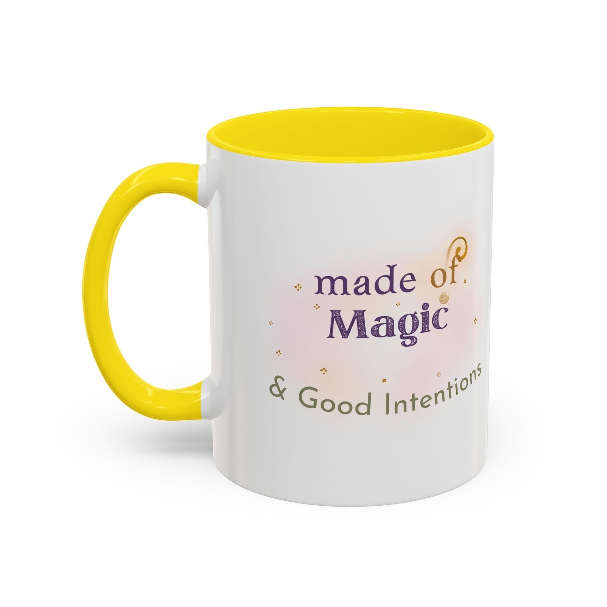 Jena Jewelry white ceramic mug with yellow interior and handle, featuring the text “made of Magic & Good Intentions” in purple and green.
