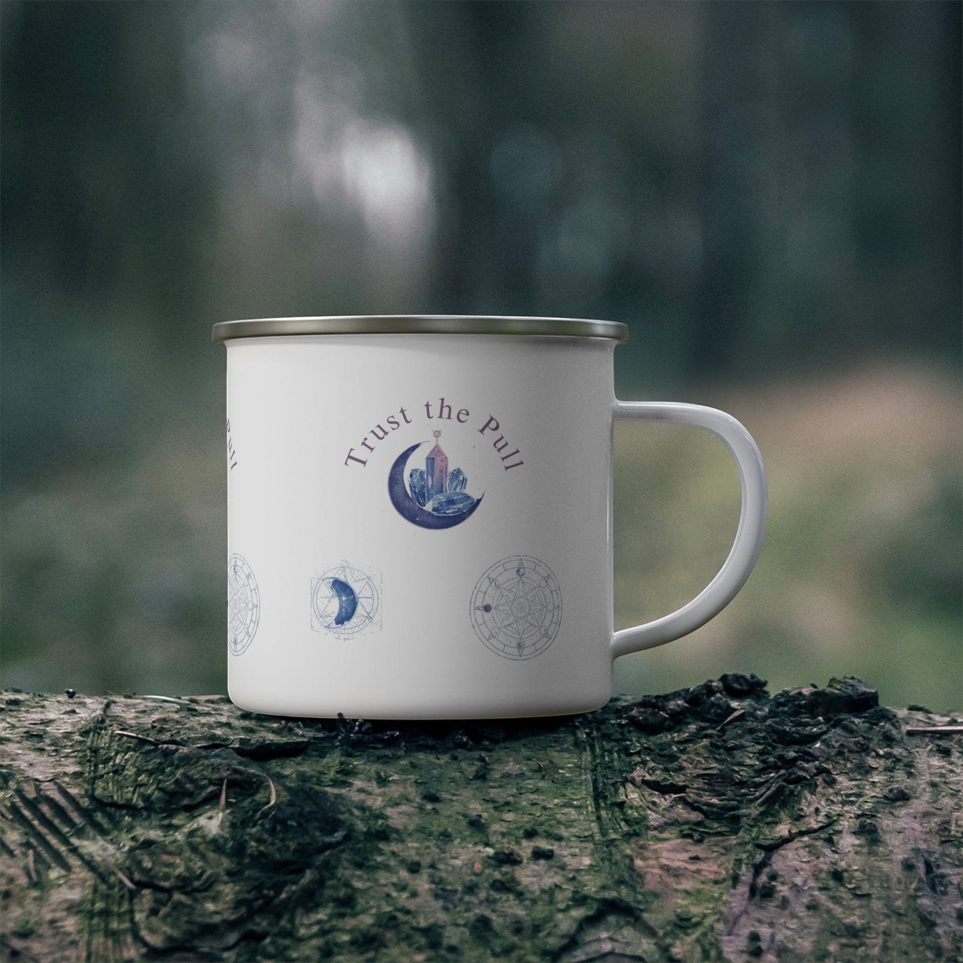 White enamel camping mug with "Trust the Pull" moon phase design, crystals, and celestial symbols. Perfect for coffee lovers and outdoor adventures.