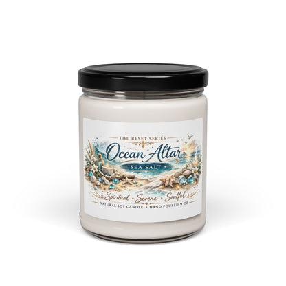 Jena Jewelry Ocean Altar sea salt scented soy candle in a clear glass jar with a black lid. Features a beach-themed label.