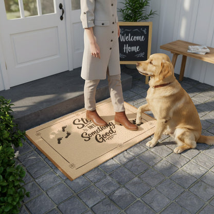 Jena Jewelry natural coir doormat with black paw prints and "Step Into Something Good" text. A golden retriever sits on the mat.