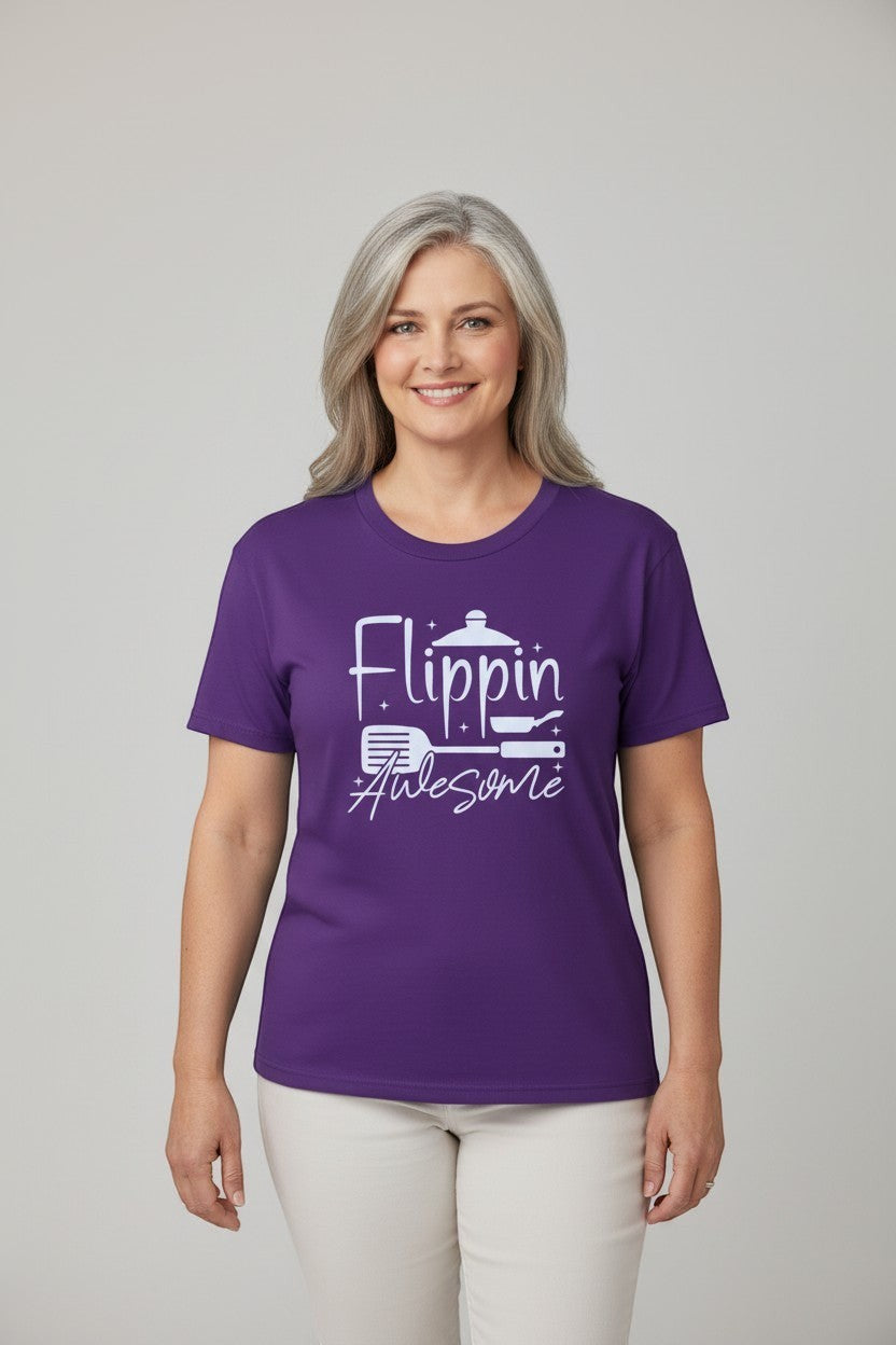 Jena Jewelry purple 100% cotton t-shirt with white graphic text 'Flippin Awesome' and cooking icons. Model is wearing a size L.