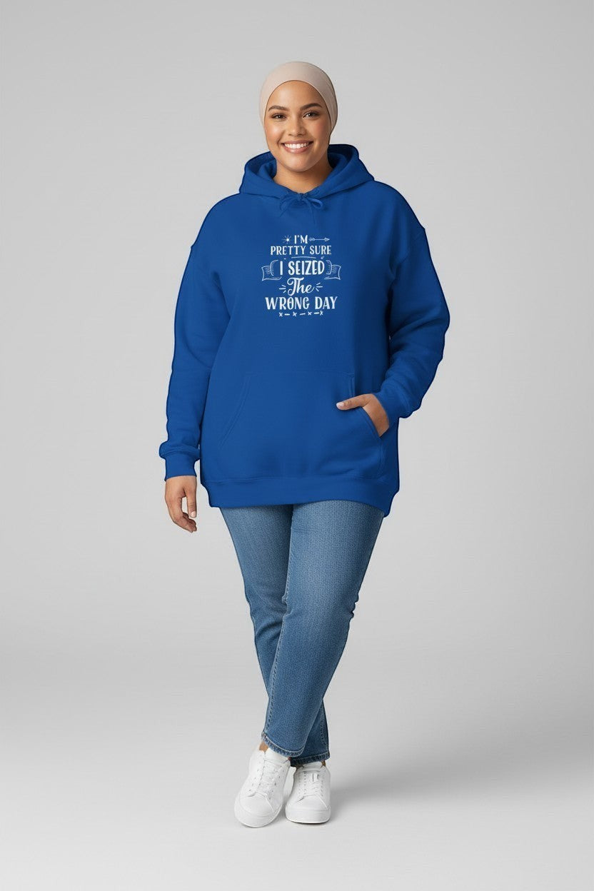 Jena Jewelry royal blue pullover hoodie with white text "I'm Pretty Sure I Seized The Wrong Day". Model wears jeans and white sneakers.
