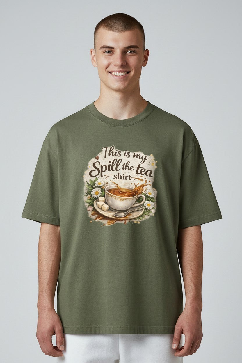 Man wearing oversized green “Spill the Tea” shirt, perfect for relaxed streetwear and casual styling.