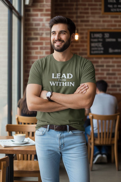 Man wearing green “Lead From Within” t-shirt in a café setting, a confident and inspiring everyday look.