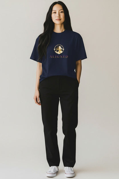 Woman wearing navy “Aligned” t-shirt with gold symbol design, a clean and intentional style.