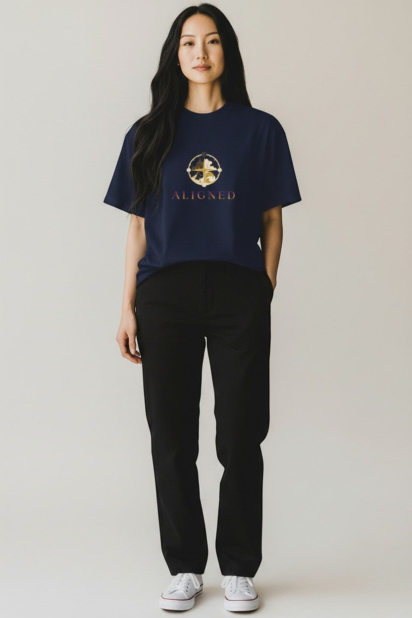 Woman wearing navy “Aligned” t-shirt with gold symbol design, a clean and intentional style.