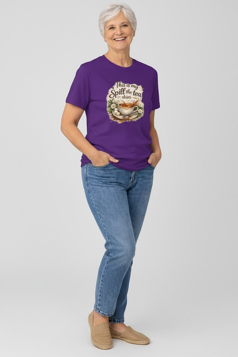 Older woman wearing purple “Spill the Tea” shirt, a fun and comfortable graphic tee for all ages.