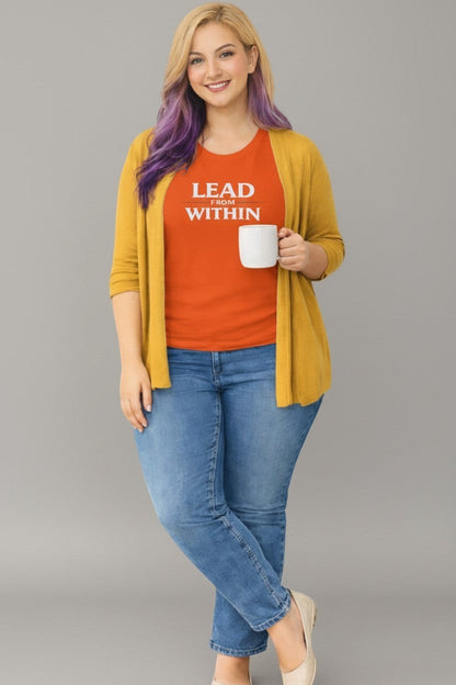 Woman wearing orange “Lead From Within” t-shirt, a bright and confident everyday style.